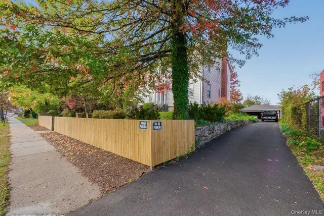 a couple of flower plants in front of a house