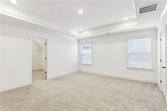 an empty room with a windows and closet