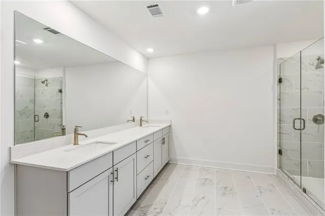 a bathroom with 2 sink and a mirror