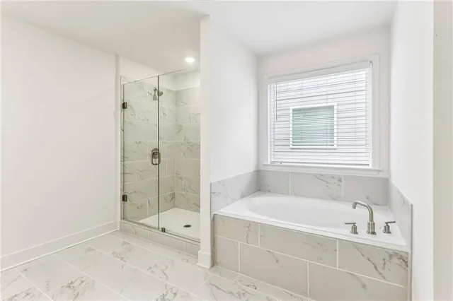 a spacious bathroom with a bathtub and a shower