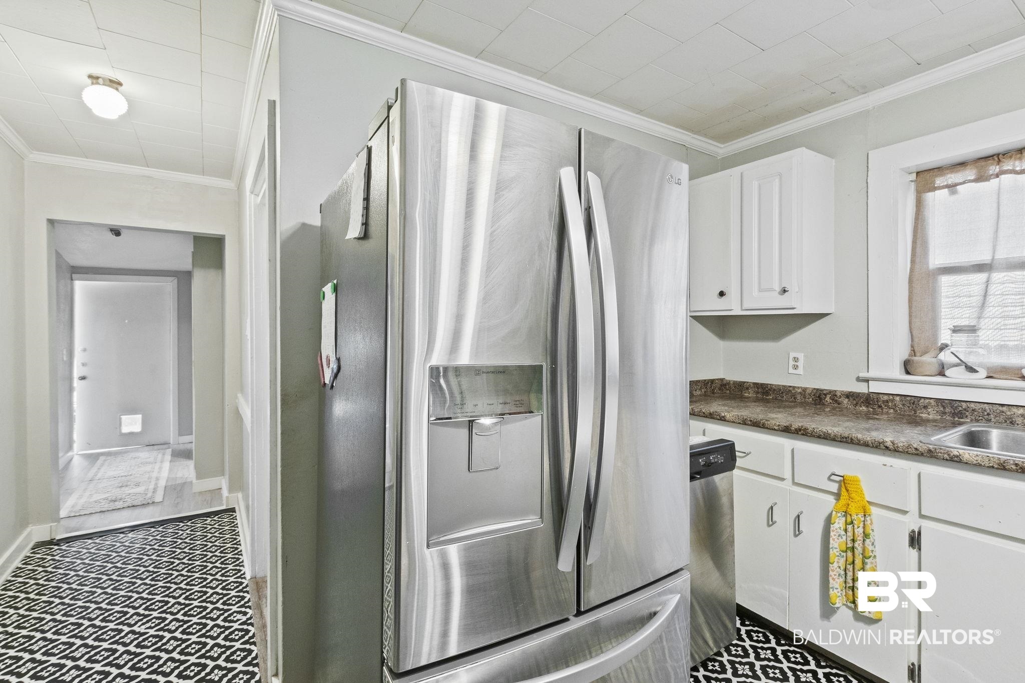 707 North Cedar Street Foley, AL 36535 - Photo 21 of 69 Kitchen featuring crown molding, stainless steel appliances, and white cabinets