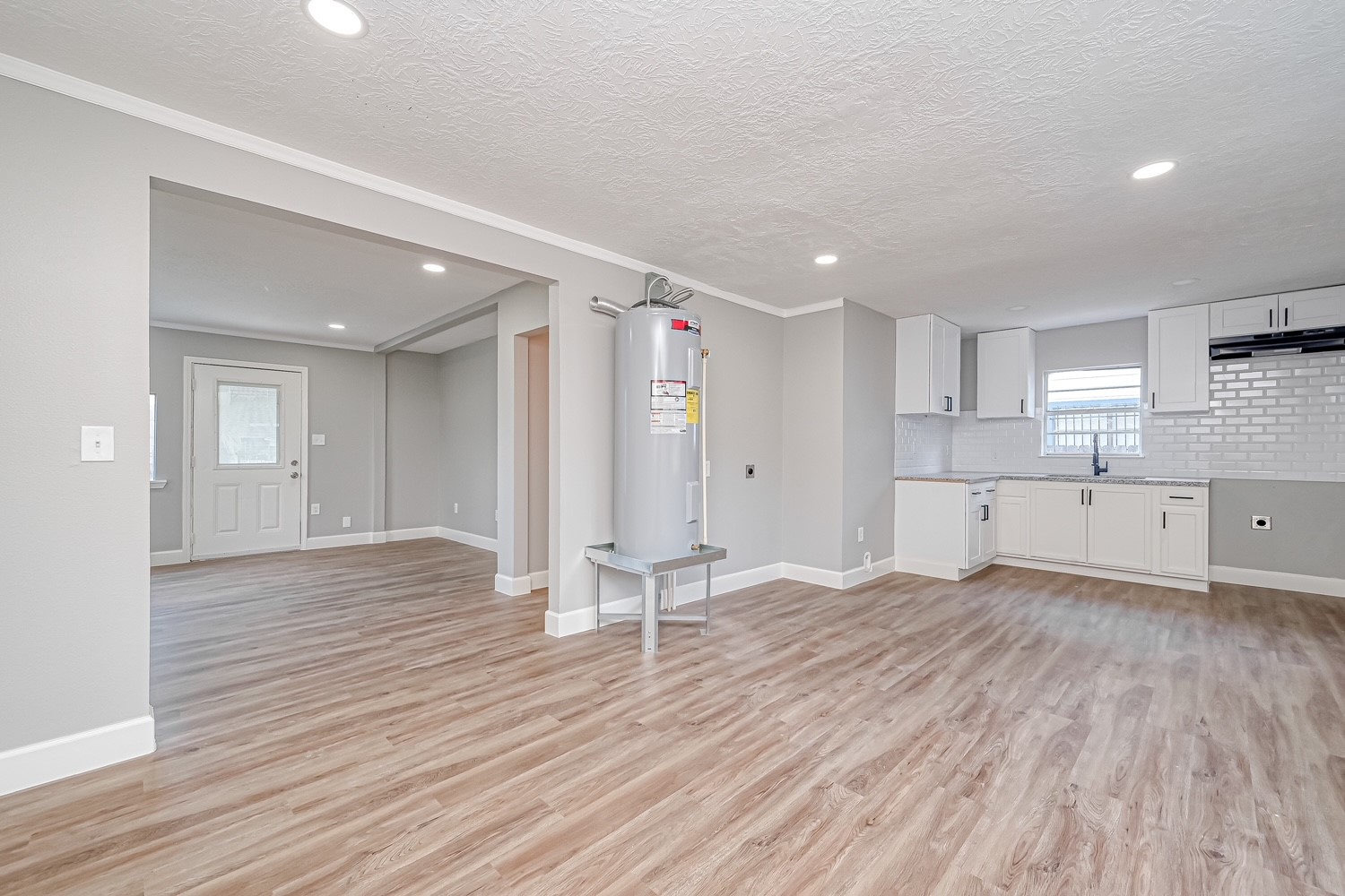 6715 Victoria Street, Unit A Houston, TX 77020 - Photo 11 of 34 a view of a kitchen with wooden floor and a sink