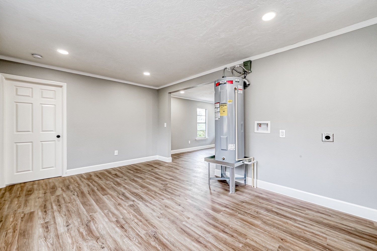 6715 Victoria Street, Unit A Houston, TX 77020 - Photo 13 of 34 a view of an empty room with wooden floor and a bathroom