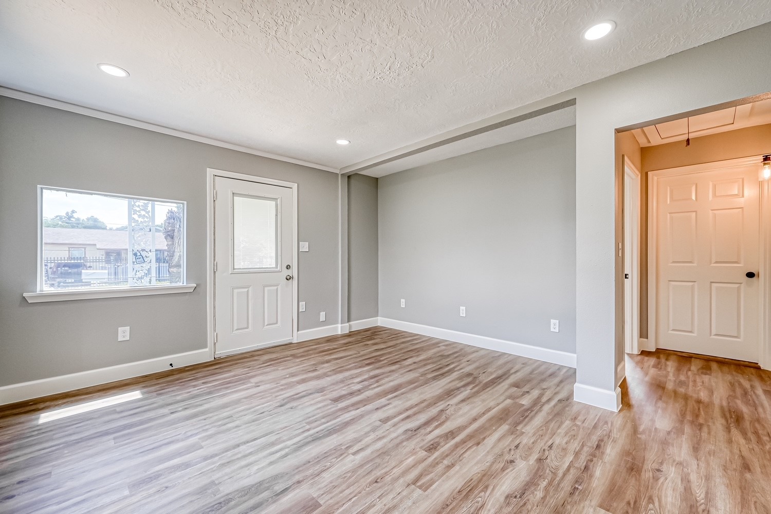 6715 Victoria Street, Unit A Houston, TX 77020 - Photo 6 of 34 a view of an empty room with wooden floor and a window