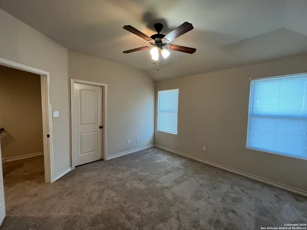 a view of an empty room with a ceiling fan