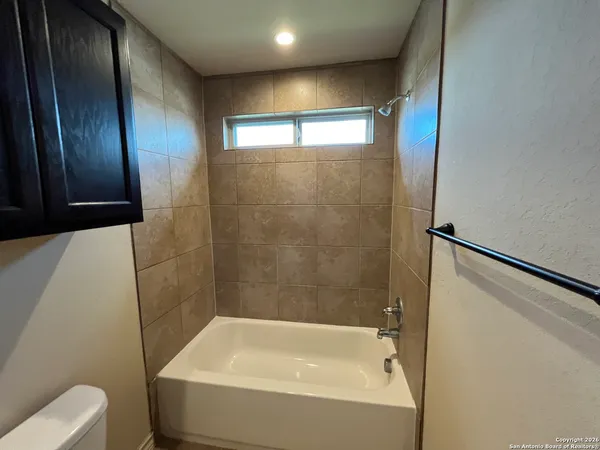 a bathroom with a bathtub and toilet