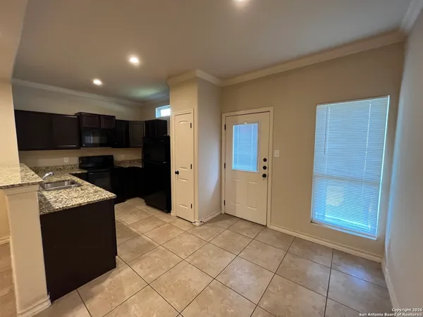 a kitchen with stainless steel appliances granite countertop a refrigerator and a stove