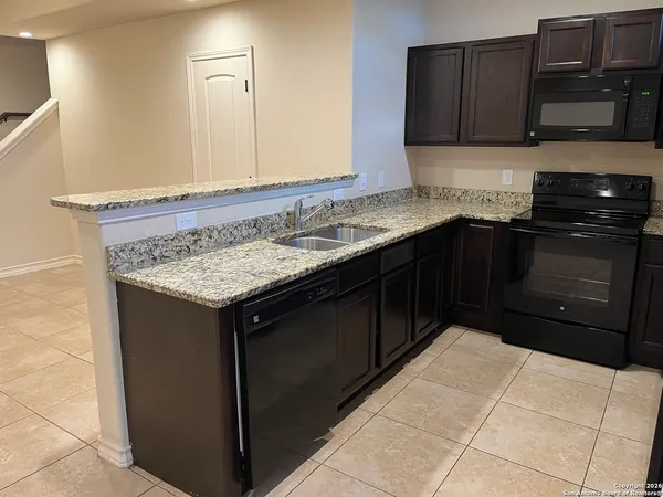 a kitchen with a sink stove and microwave
