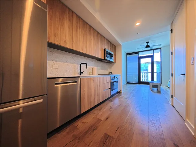 a kitchen with stainless steel appliances granite countertop a refrigerator and a sink