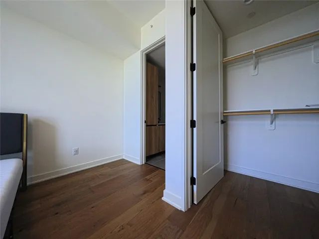 an empty room with wooden floor and a window