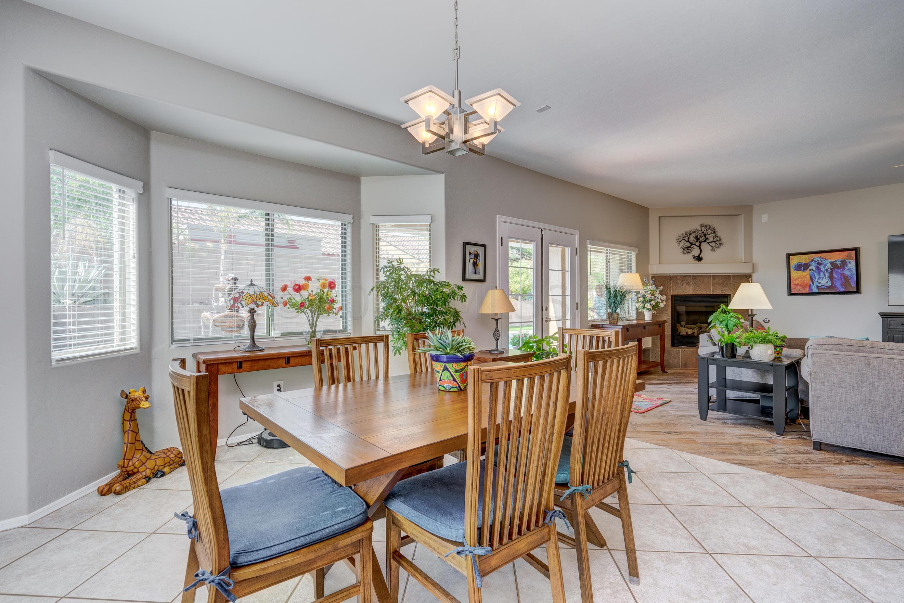 3639 East Northern Dancer Road Tucson, AZ 85739 - Photo 12 of 48 a dining room with furniture a window and wooden floor
