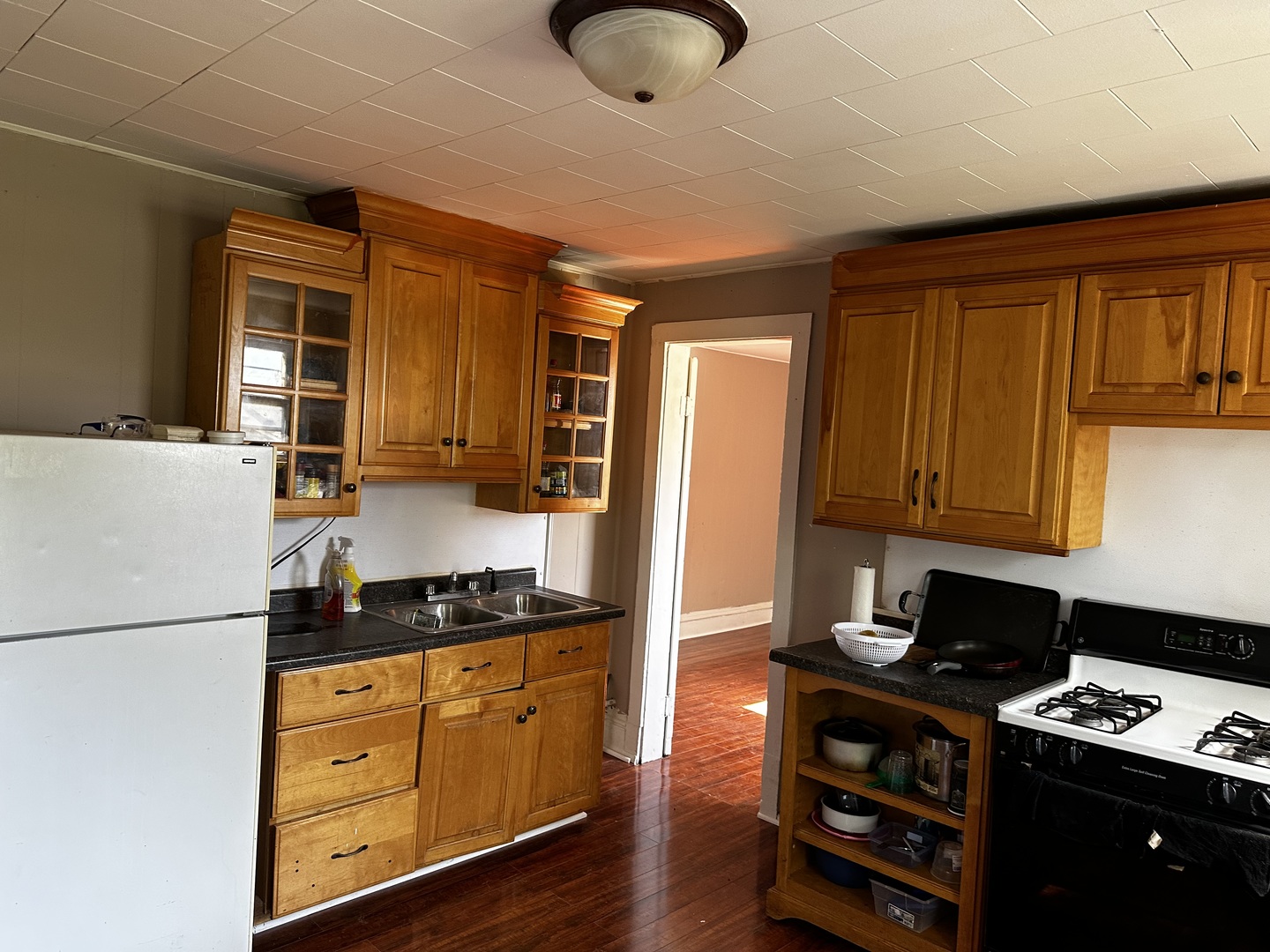 Undisclosed Address Aurora, IL 60505 - Photo 3 of 8 a kitchen with granite countertop cabinets stove top oven and sink