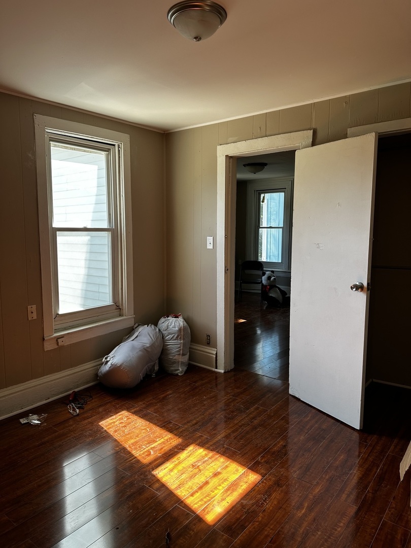 Undisclosed Address Aurora, IL 60505 - Photo 4 of 8 a bedroom with wooden floor and windows