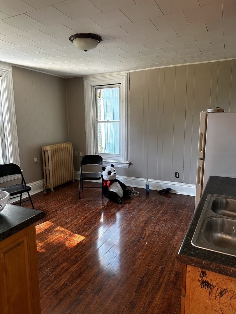 Undisclosed Address Aurora, IL 60505 - Photo 6 of 8 a living room with furniture and a wooden floor