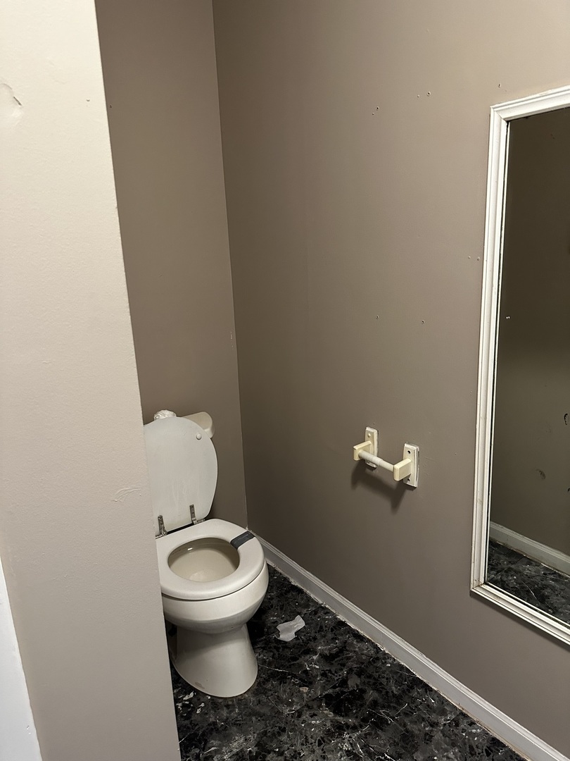 Undisclosed Address Aurora, IL 60505 - Photo 7 of 8 a white toilet sitting in a bathroom