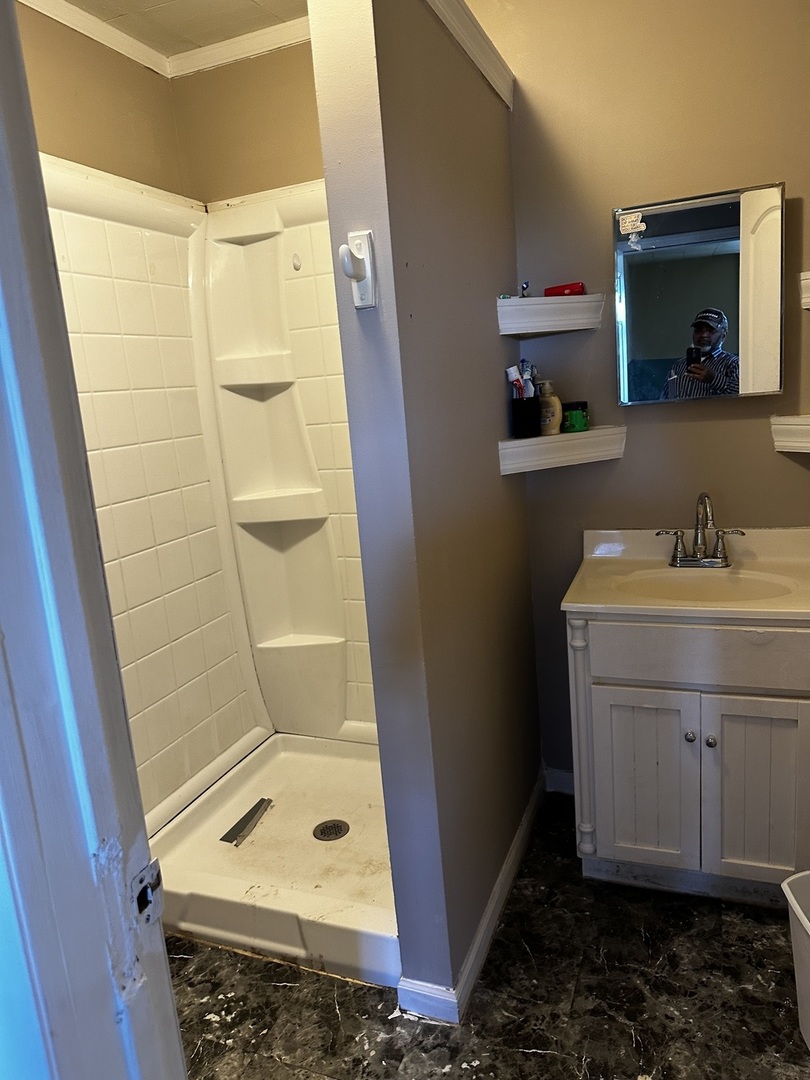 Undisclosed Address Aurora, IL 60505 - Photo 8 of 8 a bathroom with a sink a toilet and shower