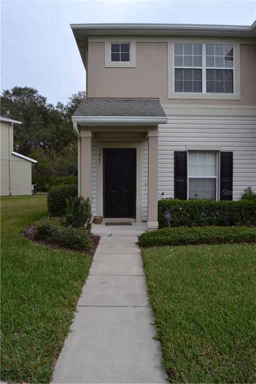 5843 Fishhawk Ridge Drive Lithia, FL 33547 - Photo 1 of 1 a front view of a house with a yard and potted plants