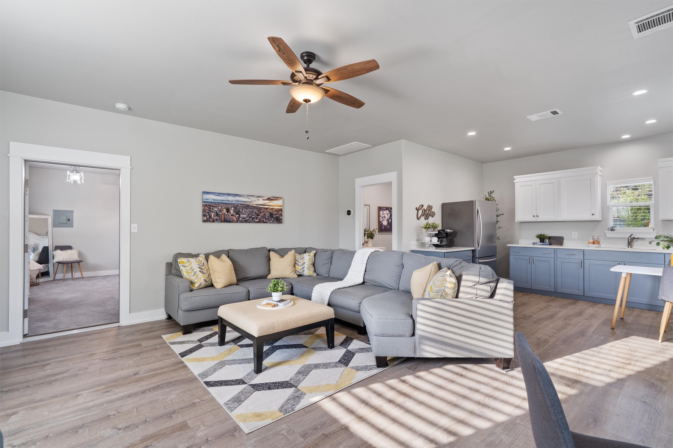 13105 Rooster Springs Road Austin, TX 78737 - Photo 29 of 38 The open concept living area features light-toned flooring and a ceiling fan with integrated lighting