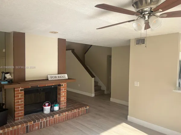 a kitchen with a refrigerator sink and cabinets