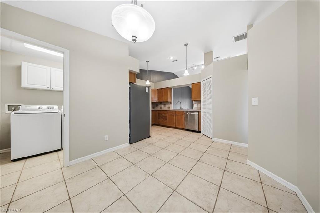430 St Andrews Boulevard, Unit 6 Naples, FL 34113 - Photo 16 of 47 a view of a kitchen with furniture and an empty room