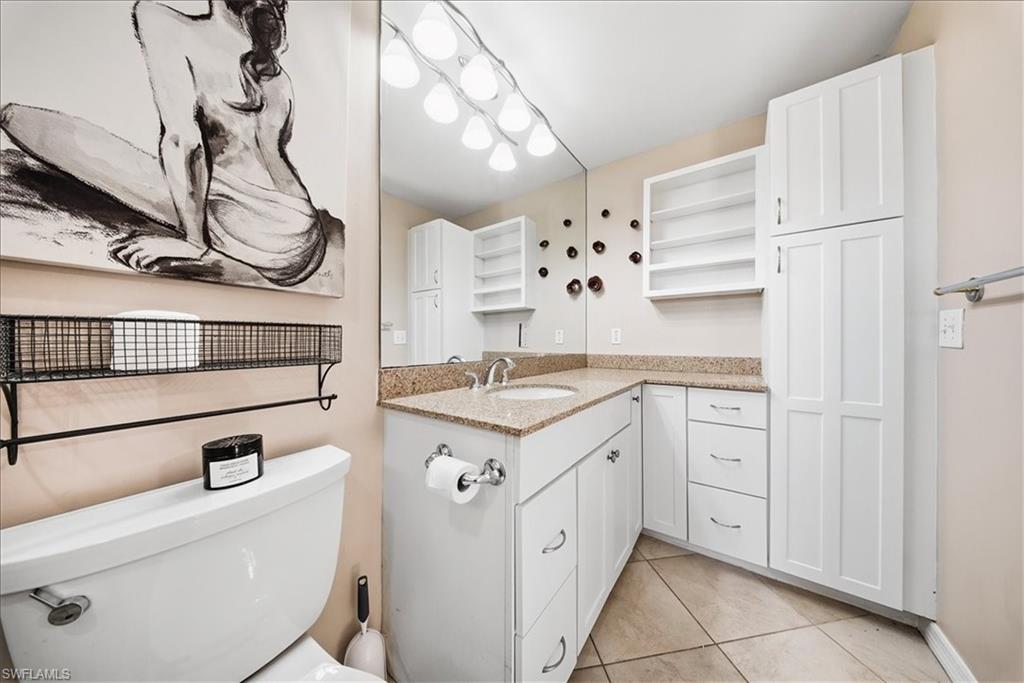 430 St Andrews Boulevard, Unit 6 Naples, FL 34113 - Photo 19 of 47 a bathroom with a sink double vanity and a mirror