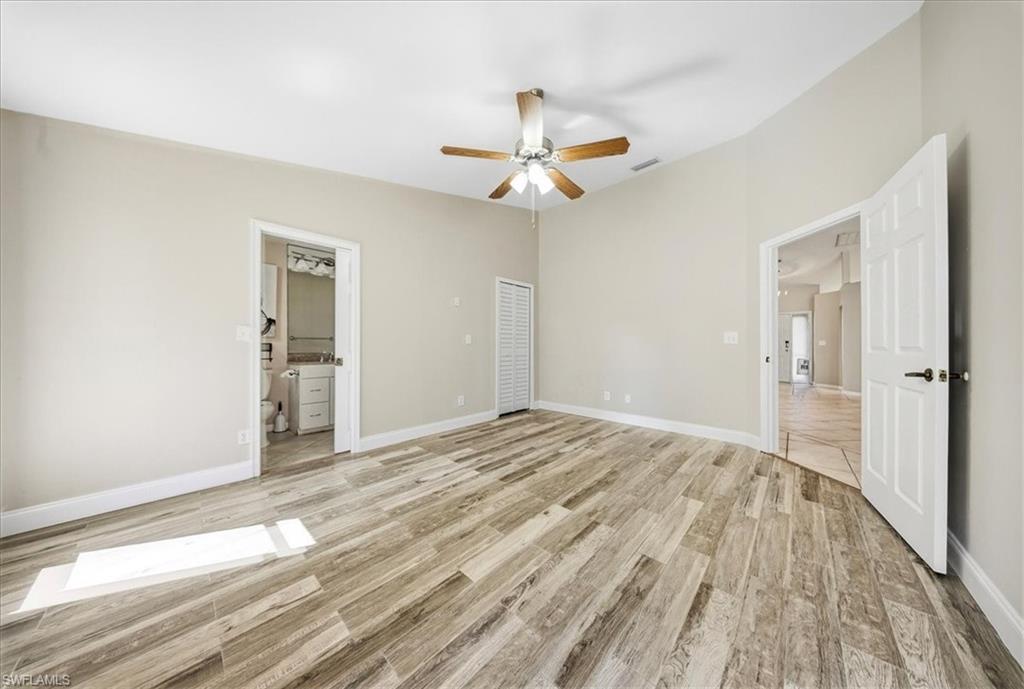 430 St Andrews Boulevard, Unit 6 Naples, FL 34113 - Photo 20 of 47 a view of empty room with wooden floor and fan