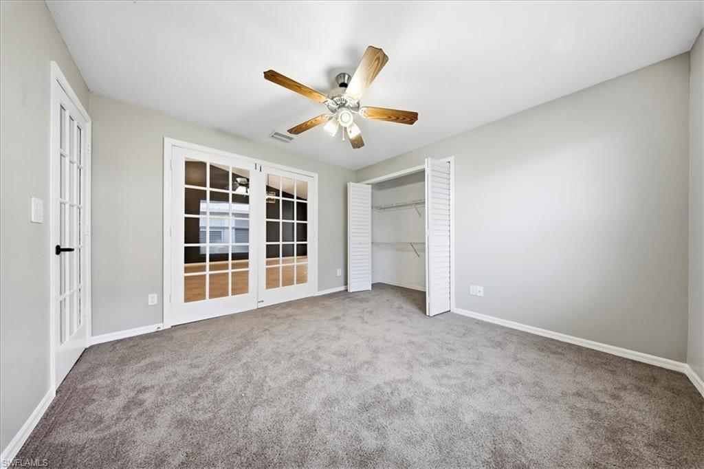 430 St Andrews Boulevard, Unit 6 Naples, FL 34113 - Photo 22 of 47 an empty room with closet and windows