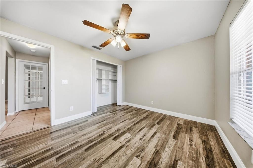 430 St Andrews Boulevard, Unit 6 Naples, FL 34113 - Photo 24 of 47 wooden floor in an empty room with a window