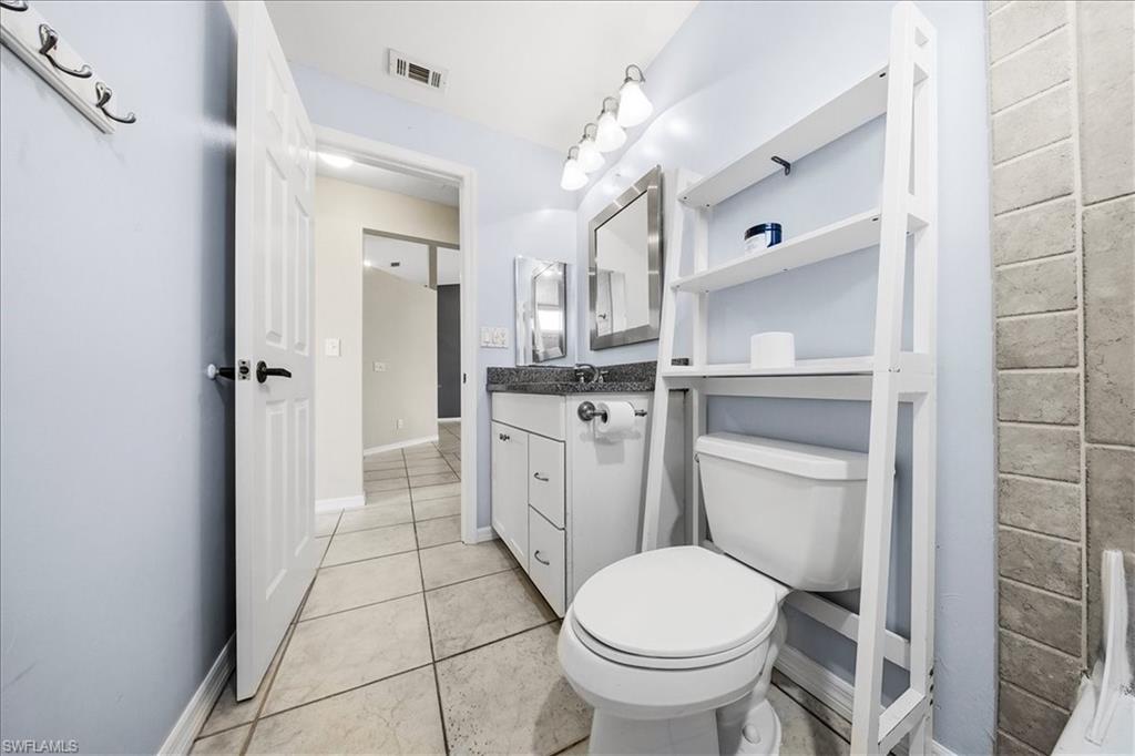 430 St Andrews Boulevard, Unit 6 Naples, FL 34113 - Photo 26 of 47 a bathroom with a sink toilet and shower