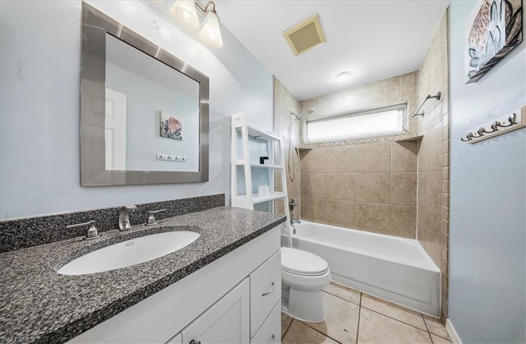 430 St Andrews Boulevard, Unit 6 Naples, FL 34113 - Photo 27 of 47 a bathroom with a granite countertop sink toilet and shower