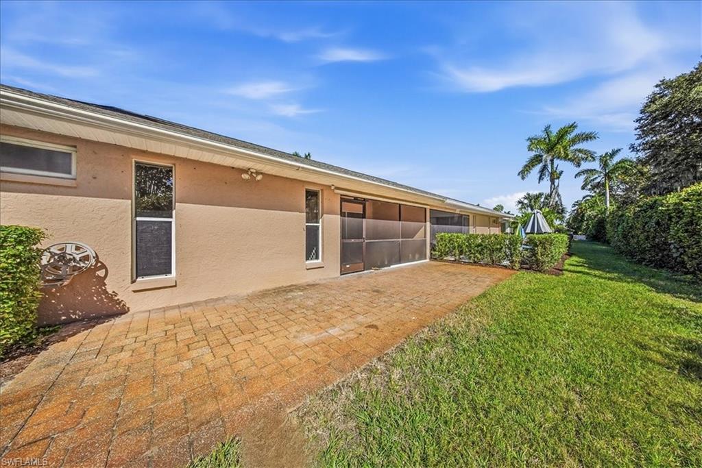 430 St Andrews Boulevard, Unit 6 Naples, FL 34113 - Photo 35 of 47 a front view of a house with garden