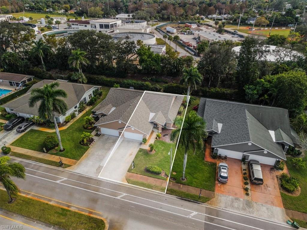 430 St Andrews Boulevard, Unit 6 Naples, FL 34113 - Photo 39 of 47 an aerial view of multiple houses with yard