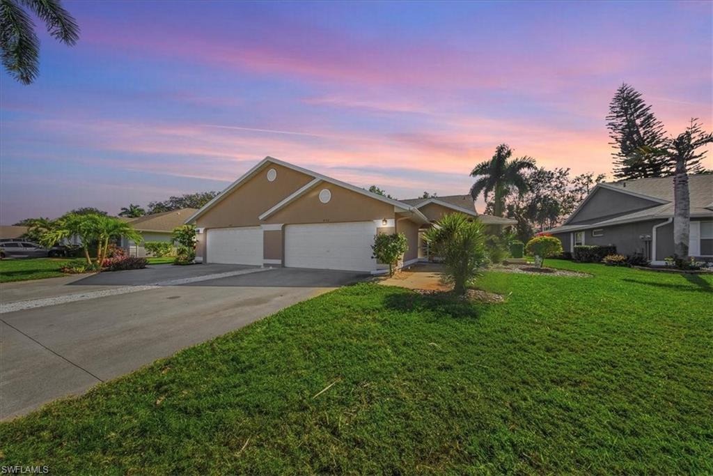 430 St Andrews Boulevard, Unit 6 Naples, FL 34113 - Photo 47 of 47 a front view of a house with garden
