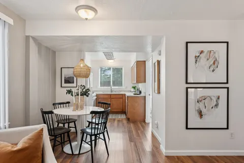 a view of a dining room with furniture and wooden floor