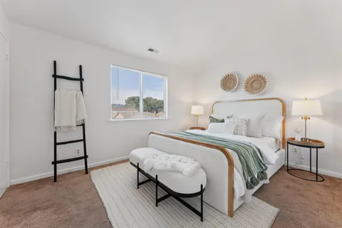 a bedroom with a bed and a window