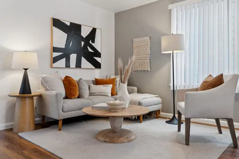 a living room with furniture and a lamp