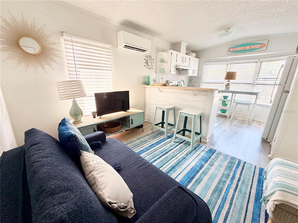 2201 South Ridgewood Avenue, Unit 23 Edgewater, FL 32141 - Photo 6 of 8 a living room with furniture and a flat screen tv