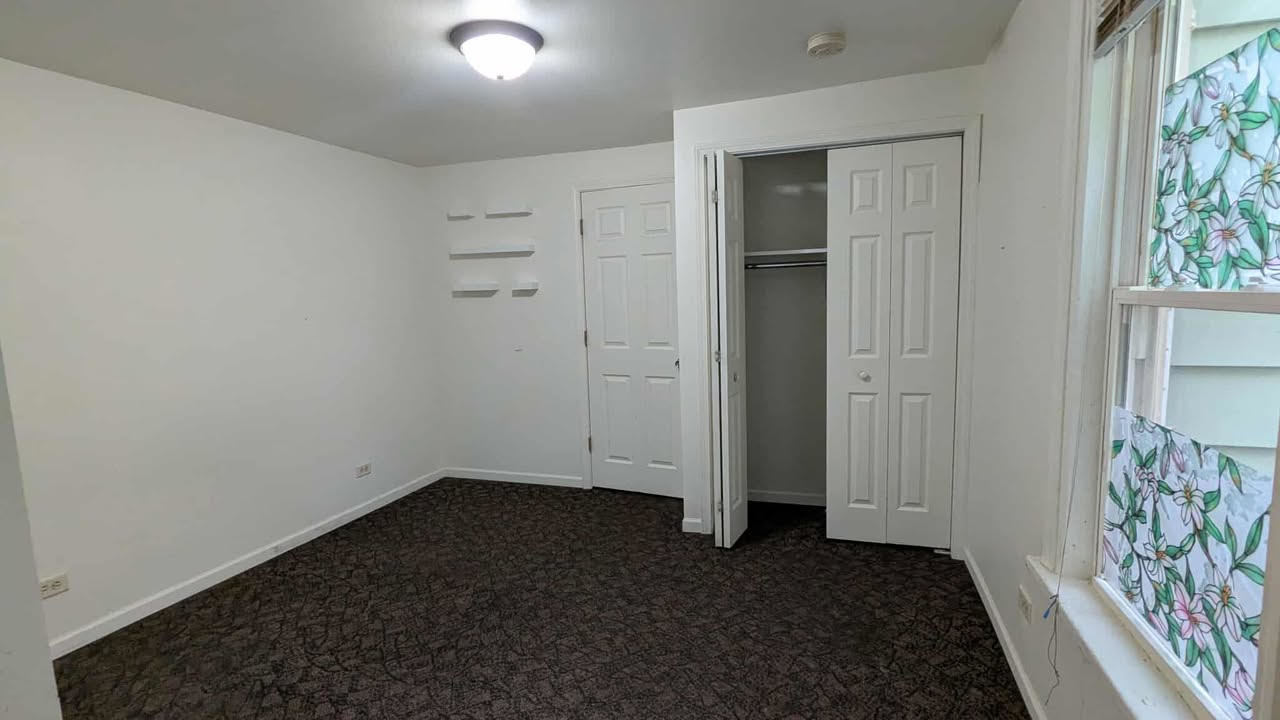 714 Glen Rock Avenue, Unit 3 Waukegan, IL 60085 - Photo 2 of 4 an empty room with windows