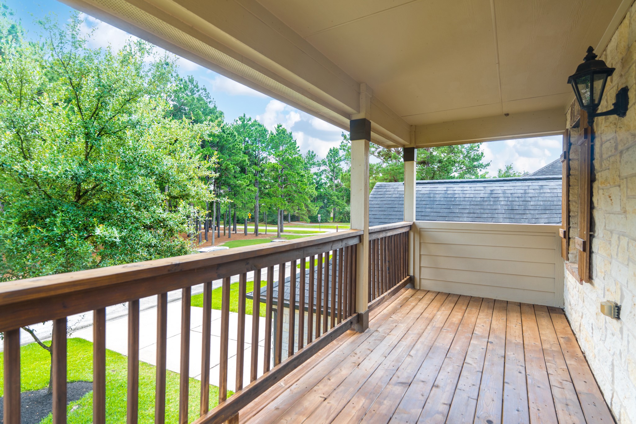 79 West Jagged Ridge Circle Spring, TX 77389 - Photo 31 of 50 Step out onto this private second-floor covered balcony and enjoy peaceful views of mature trees and the surrounding community. It's the perfect spot for morning coffee or evening relaxation, tucked away from the hustle and bustle below.