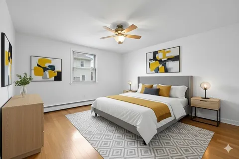 a bedroom with a bed and a dresser next to it