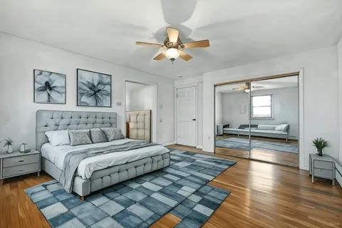 a spacious bedroom with a bed and a chandelier
