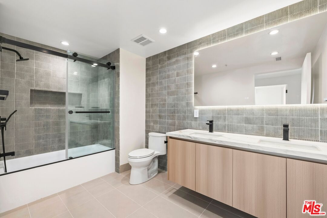 1414 1/2 South Beverly Drive, Unit 402 Los Angeles, CA 90035 - Photo 12 of 15 a bathroom with a sink and mirror with toilet