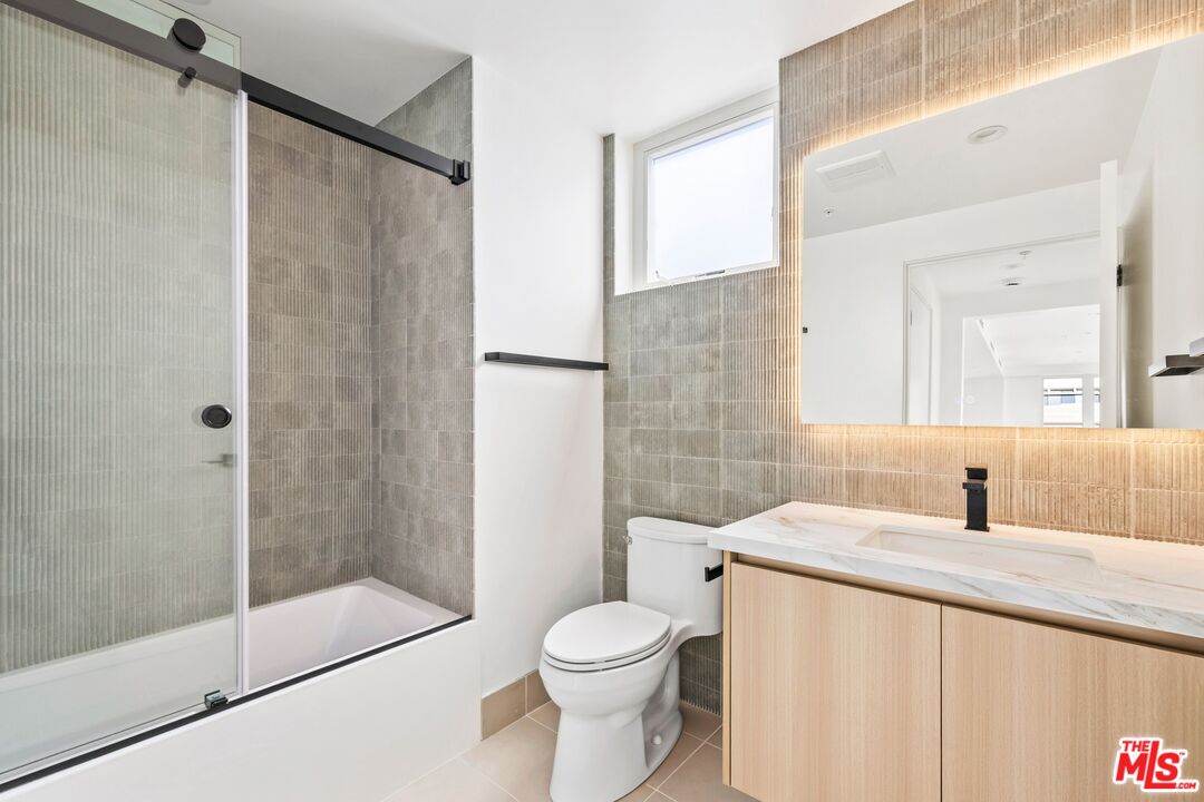 1414 1/2 South Beverly Drive, Unit 402 Los Angeles, CA 90035 - Photo 8 of 15 a bathroom with a sink toilet and shower