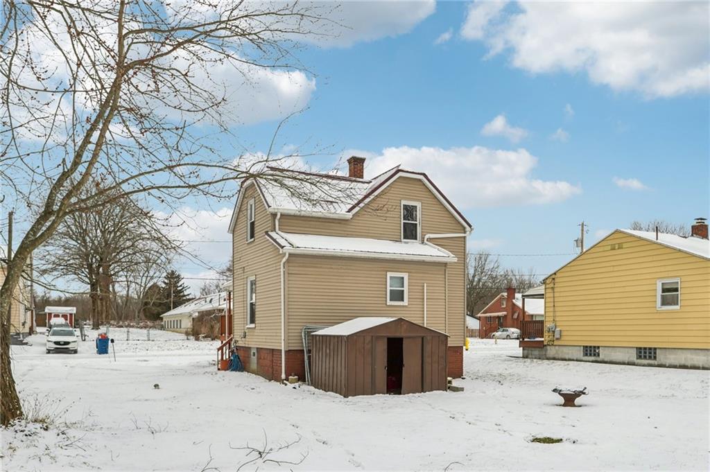 14 Elm Street Bessemer, PA 16112 - Photo 5 of 29 a view of a house with a snow in the yard
