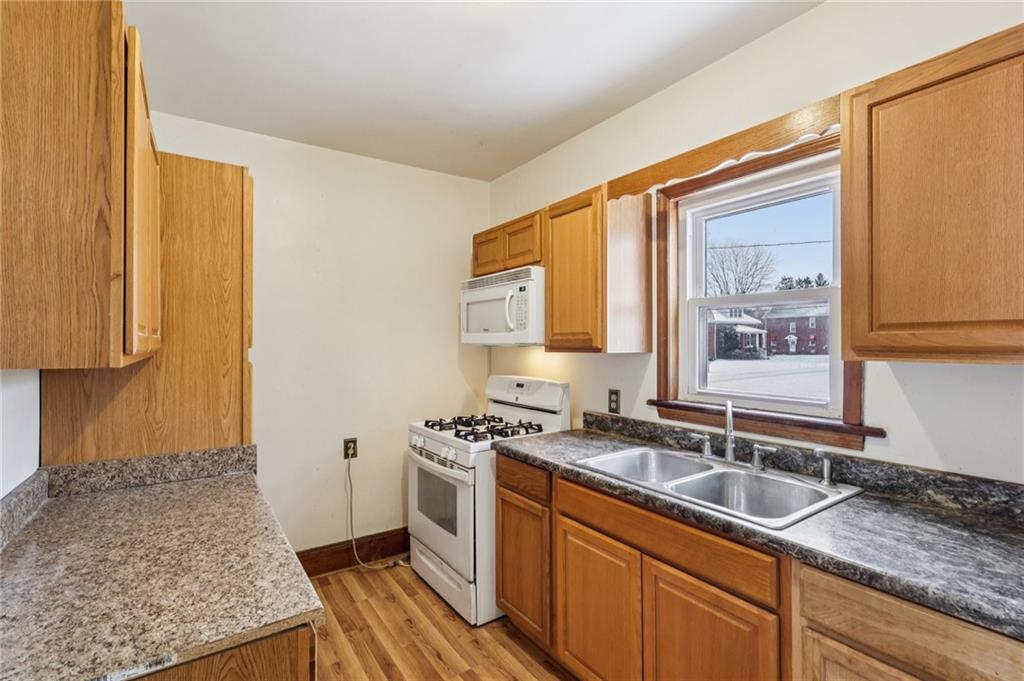14 Elm Street Bessemer, PA 16112 - Photo 9 of 29 a kitchen that has a sink and a stove