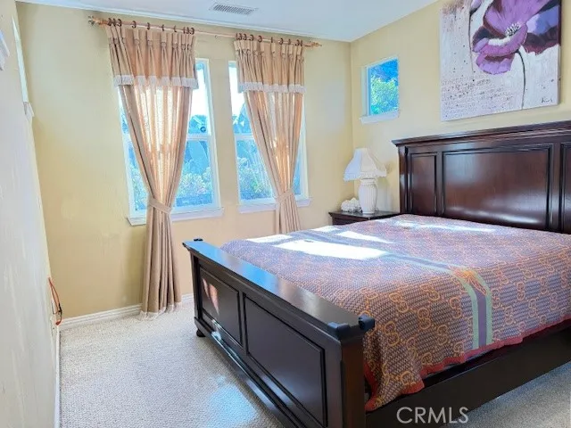 a bedroom with a bed and dresser