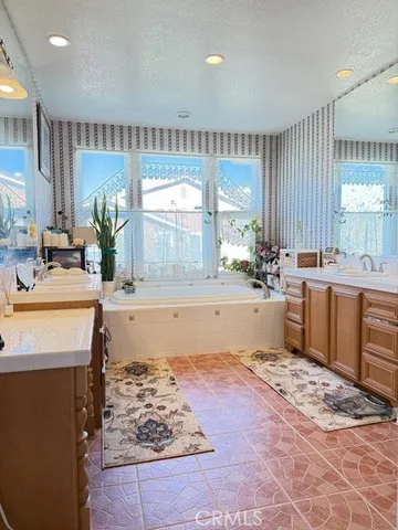 a bathroom with a sink a mirror and a shower