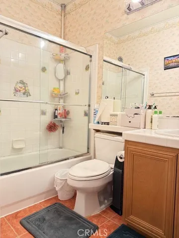 a bathroom with a toilet a sink and shower