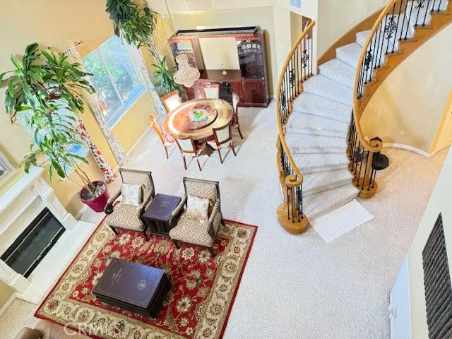 an ocean view with couches chair and a fireplace with wooden floor