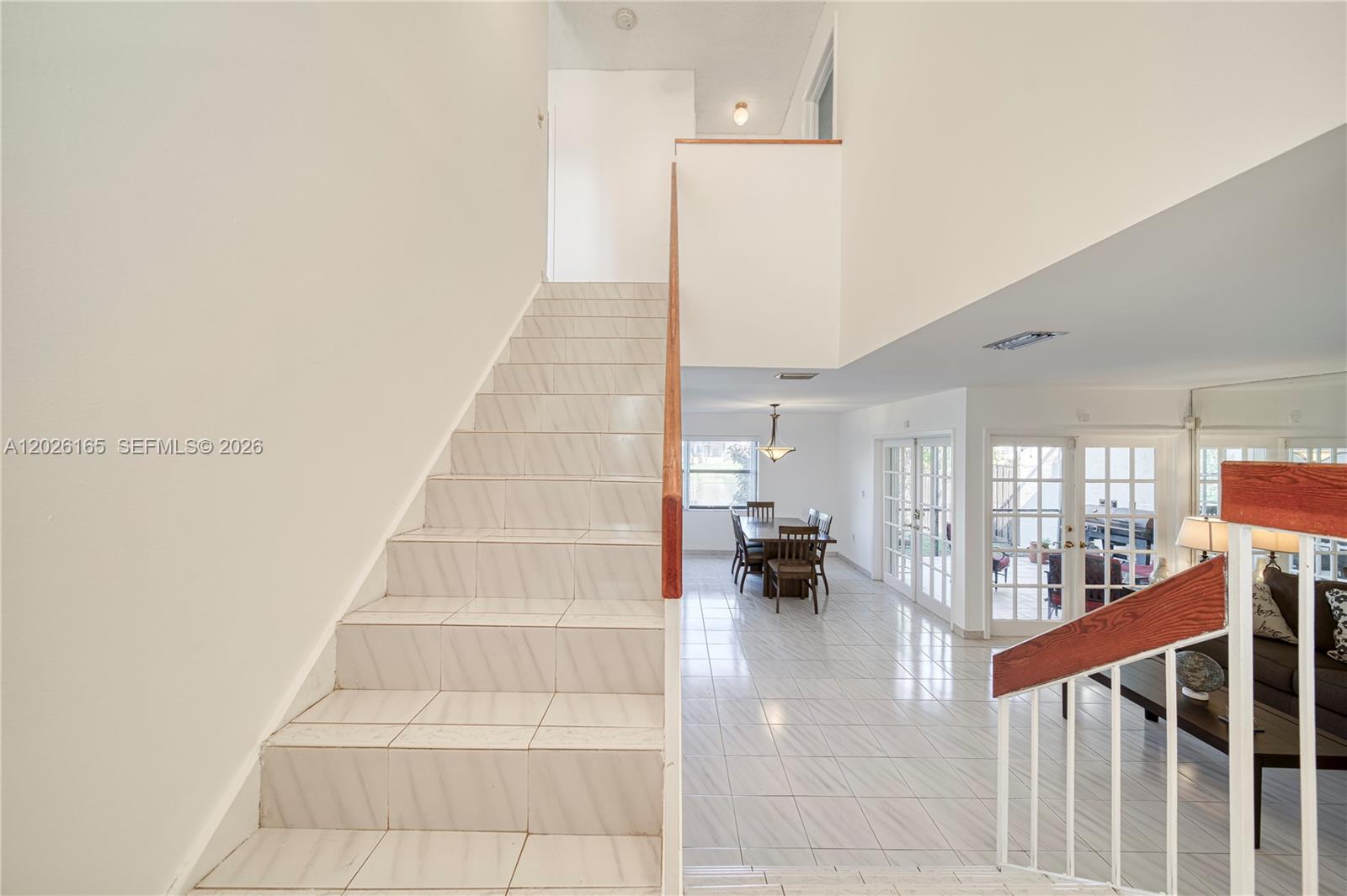 13337 Southwest 64th Lane Miami, FL 33183 - Photo 6 of 36 a view of staircase with white walls and railing
